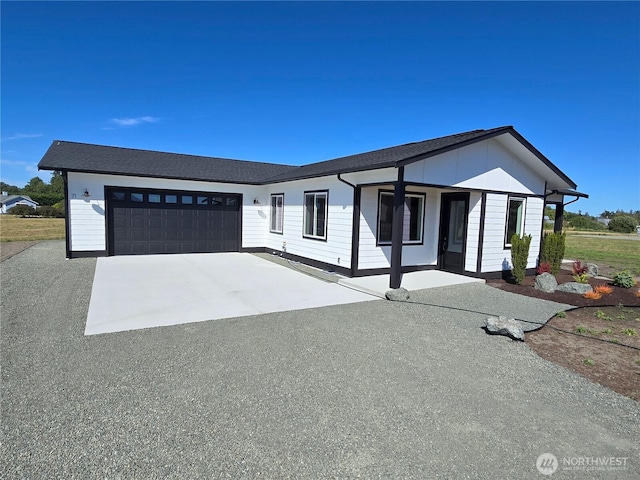 71 Falconcrest Ct, Sequim, WA 98382 - view of front of house featuring a garage, driveway, and covered porch