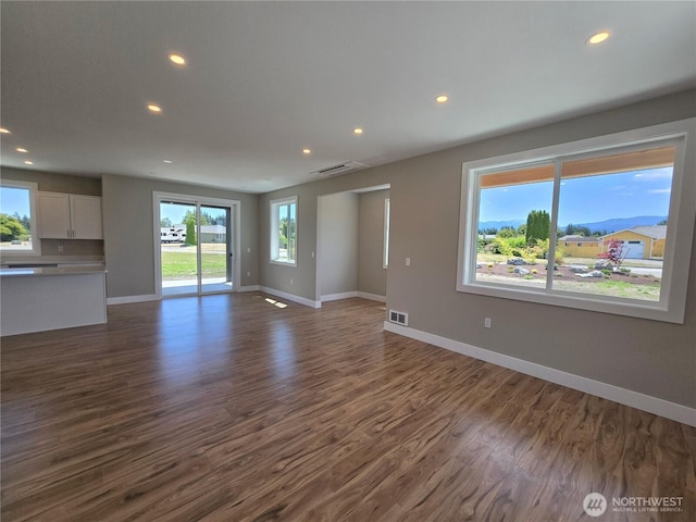 71 Falconcrest Ct, Sequim, WA 98382 - unfurnished living room with dark wood-style flooring and recessed lighting