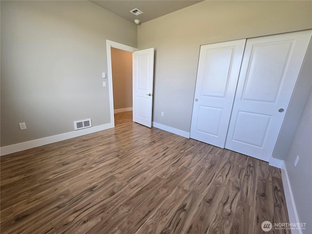 71 Falconcrest Ct, Sequim, WA 98382 - unfurnished bedroom featuring wood finished floors and a closet