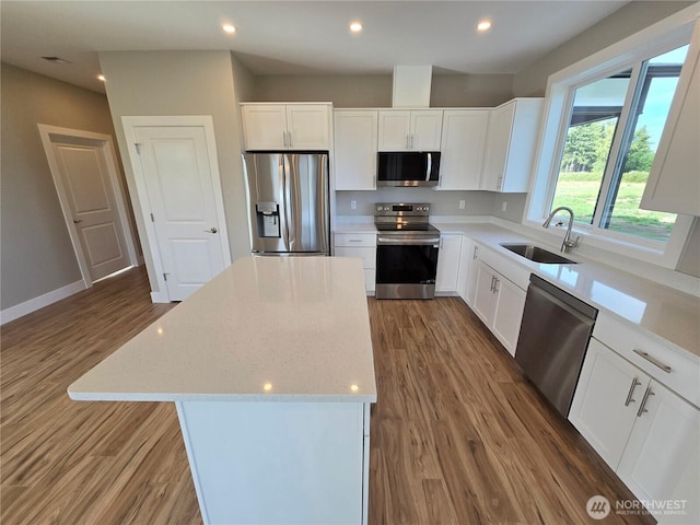 71 Falconcrest Ct, Sequim, WA 98382 - kitchen featuring stainless steel appliances, light wood-style flooring, a kitchen island, light stone counters, and recessed lighting