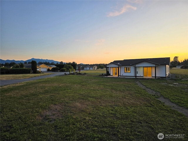 71 Falconcrest Ct, Sequim, WA 98382 - yard at dusk featuring a yard and a mountain view