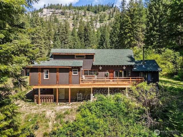 16845 Second Creek Rd, Leavenworth, WA 98826 - rear view of property featuring a deck, a forest view, and a shingled roof