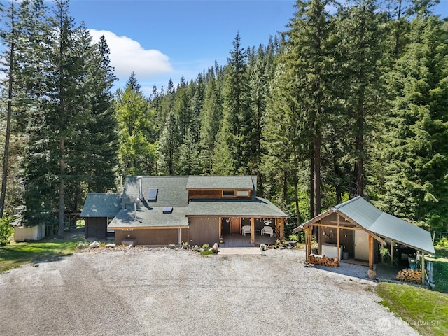 16845 Second Creek Rd, Leavenworth, WA 98826 - chalet / cabin featuring gravel driveway, a wooded view, roof with shingles, and a porch
