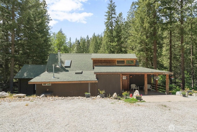 16845 Second Creek Rd, Leavenworth, WA 98826 - chalet / cabin featuring a shingled roof, a forest view, and driveway