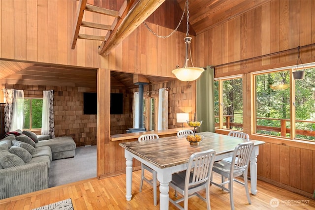 16845 Second Creek Rd, Leavenworth, WA 98826 - dining space featuring wood walls, high vaulted ceiling, light wood-type flooring, a wood stove, and a wood ceiling with exposed beams