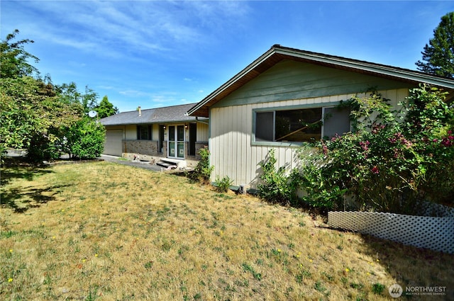 113 19th Ave SE, Puyallup, WA 98372 - rear view of house with a garage and a yard