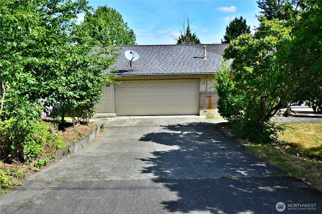 113 19th Ave SE, Puyallup, WA 98372 - view of front facade featuring brick siding, a shingled roof, asphalt driveway, and an attached garage