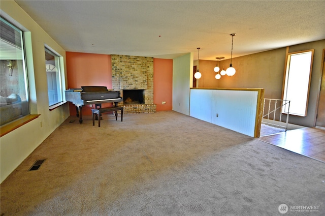 113 19th Ave SE, Puyallup, WA 98372 - sitting room with carpet, an upstairs landing, a brick fireplace, and a chandelier