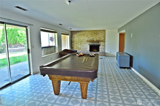 113 19th Ave SE, Puyallup, WA 98372 - recreation room with a textured ceiling, billiards table, a fireplace, and light floors