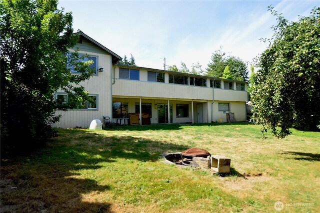 113 19th Ave SE, Puyallup, WA 98372 - rear view of property featuring an outdoor fire pit and a yard