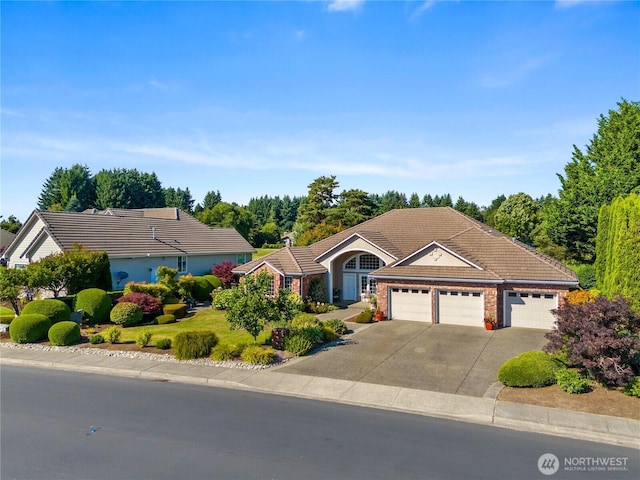 3912 Prestwick Ln SE, Olympia, WA 98501 - ranch-style house with a tile roof, a garage, and driveway
