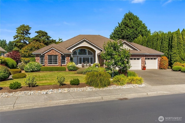 3912 Prestwick Ln SE, Olympia, WA 98501 - single story home with an attached garage, a tile roof, driveway, and brick siding