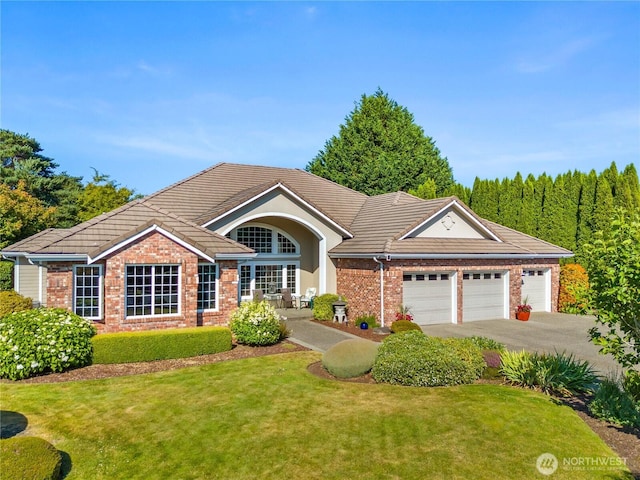 3912 Prestwick Ln SE, Olympia, WA 98501 - single story home featuring brick siding, a garage, and a front yard