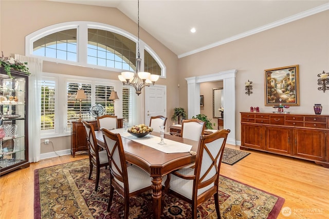 3912 Prestwick Ln SE, Olympia, WA 98501 - dining space with a chandelier, light wood-style flooring, crown molding, and lofted ceiling
