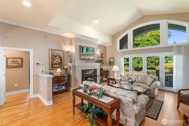 3912 Prestwick Ln SE, Olympia, WA 98501 - living area featuring a lit fireplace, light wood finished floors, and lofted ceiling