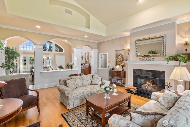 3912 Prestwick Ln SE, Olympia, WA 98501 - living room with ornate columns, a fireplace, light wood-style floors, high vaulted ceiling, and recessed lighting