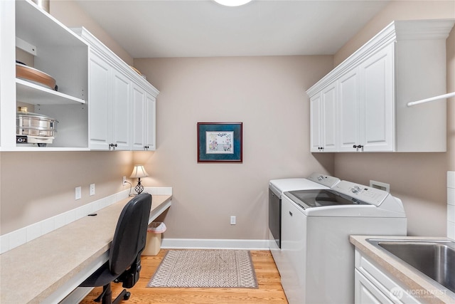 3912 Prestwick Ln SE, Olympia, WA 98501 - laundry area featuring cabinet space, washer and clothes dryer, light wood finished floors, and a desk
