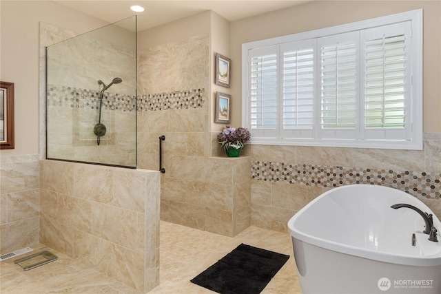 3912 Prestwick Ln SE, Olympia, WA 98501 - full bathroom with a freestanding bath, a walk in shower, healthy amount of natural light, and tile walls