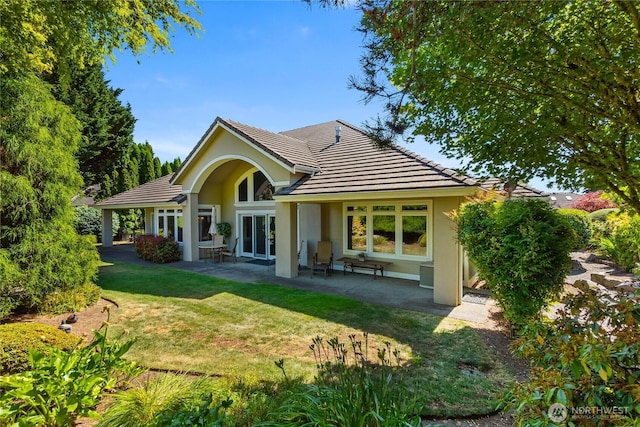 3912 Prestwick Ln SE, Olympia, WA 98501 - rear view of house with a lawn, stucco siding, a patio area, and a tiled roof