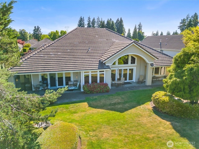 3912 Prestwick Ln SE, Olympia, WA 98501 - back of property with a tiled roof, a patio area, and a lawn