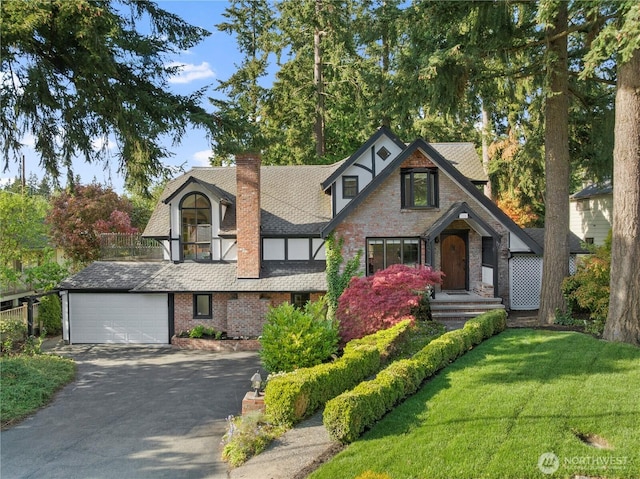118 NW 132nd St, Seattle, WA 98177 - tudor house featuring brick siding, an attached garage, asphalt driveway, and a chimney