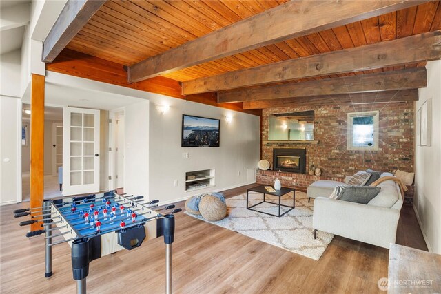118 NW 132nd St, Seattle, WA 98177 - rec room with a wood ceiling with exposed beams, wood finished floors, a fireplace, and brick wall