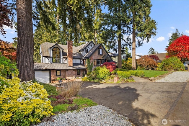 118 NW 132nd St, Seattle, WA 98177 - tudor-style house featuring brick siding, a chimney, and asphalt driveway