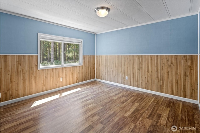27114 320th Ave SE, Ravensdale, WA 98051 - empty room featuring wood finished floors, wood walls, and wainscoting