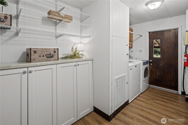 27114 320th Ave SE, Ravensdale, WA 98051 - laundry room with washing machine and clothes dryer, cabinet space, and dark wood-style flooring