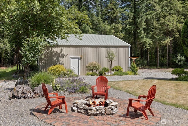 27114 320th Ave SE, Ravensdale, WA 98051 - view of patio / terrace with an outdoor fire pit and an outbuilding