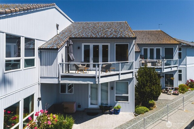 2401 Skyline Way Unit 203E, Anacortes, WA 98221 - back of house with a tile roof, a balcony, and a patio area