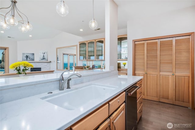 2401 Skyline Way Unit 203E, Anacortes, WA 98221 - kitchen featuring light wood-style flooring, decorative light fixtures, stainless steel dishwasher, glass insert cabinets, and recessed lighting