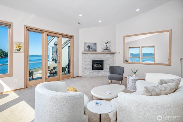 2401 Skyline Way Unit 203E, Anacortes, WA 98221 - carpeted living room featuring recessed lighting, a glass covered fireplace, and a water view
