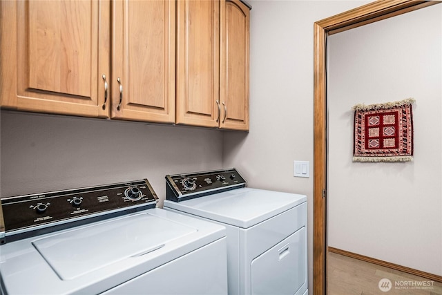2401 Skyline Way Unit 203E, Anacortes, WA 98221 - laundry room with washer and clothes dryer, cabinet space, and wood finished floors