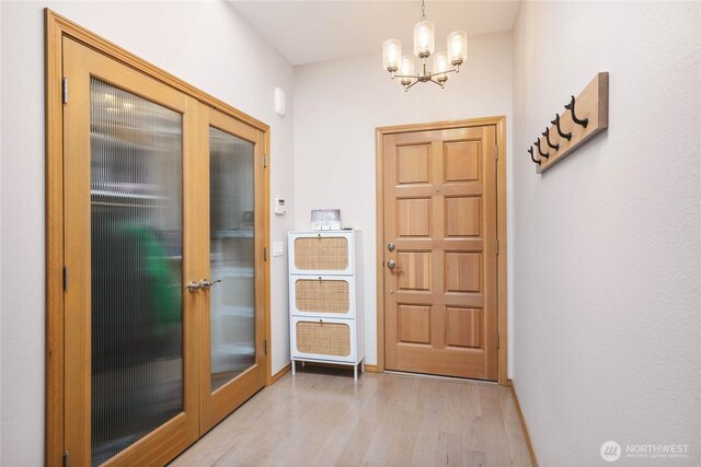 2401 Skyline Way Unit 203E, Anacortes, WA 98221 - doorway with wood finished floors, a chandelier, and french doors