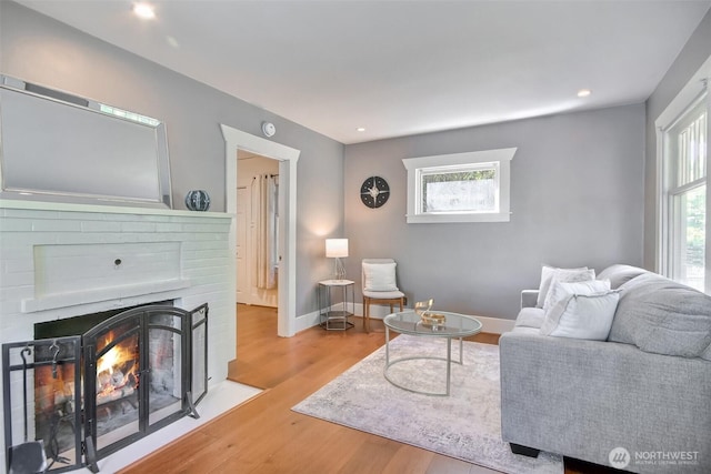 5618 35th Ave SW, Seattle, WA 98126 - living area with wood finished floors, a brick fireplace, and recessed lighting