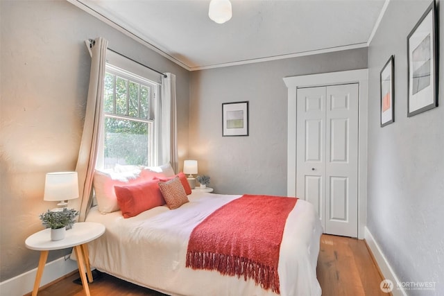 5618 35th Ave SW, Seattle, WA 98126 - bedroom featuring wood finished floors, ornamental molding, and a closet