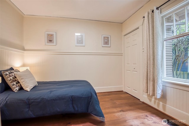 5618 35th Ave SW, Seattle, WA 98126 - bedroom featuring wood finished floors and a wainscoted wall