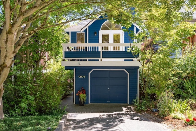 9004 20th Ave NE, Seattle, WA 98115 - view of front of property featuring asphalt driveway, a balcony, and a garage