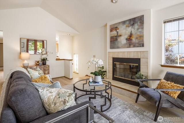 9004 20th Ave NE, Seattle, WA 98115 - living area featuring wood finished floors, a tile fireplace, and vaulted ceiling