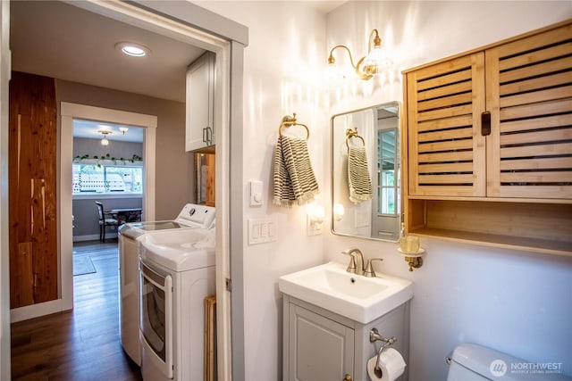 606 State St, Centralia, WA 98531 - bathroom with separate washer and dryer, vanity, and wood finished floors