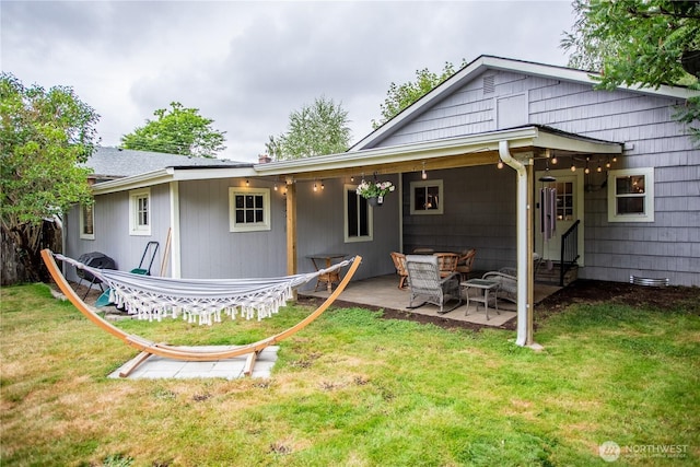 606 State St, Centralia, WA 98531 - back of house with a lawn and a patio