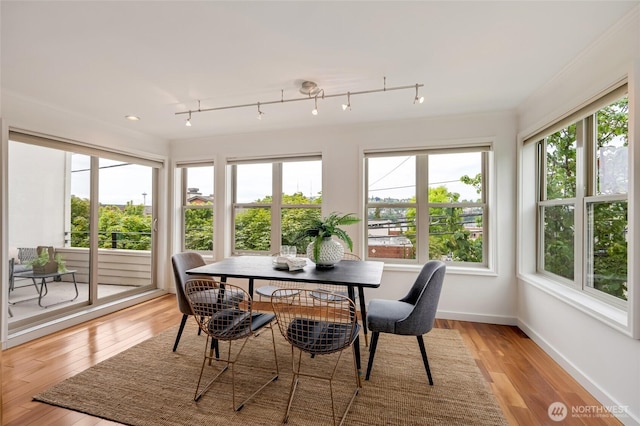 201 E Boston St Unit 2100, Seattle, WA 98102 - sunroom featuring healthy amount of natural light, wood finished floors, and rail lighting