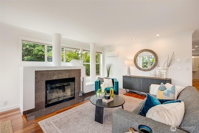 201 E Boston St Unit 2100, Seattle, WA 98102 - living room featuring an AC wall unit, a fireplace, wood finished floors, and recessed lighting