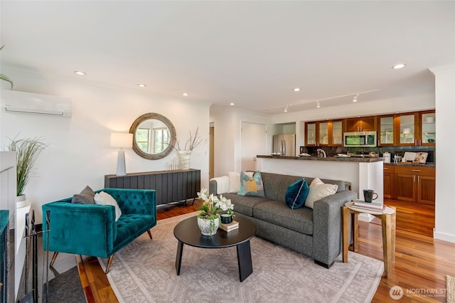 201 E Boston St Unit 2100, Seattle, WA 98102 - living area with an AC wall unit, light wood-type flooring, and recessed lighting