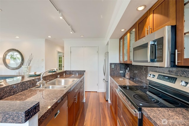 201 E Boston St Unit 2100, Seattle, WA 98102 - kitchen with stainless steel appliances, brown cabinets, light wood-style flooring, ornamental molding, and glass insert cabinets