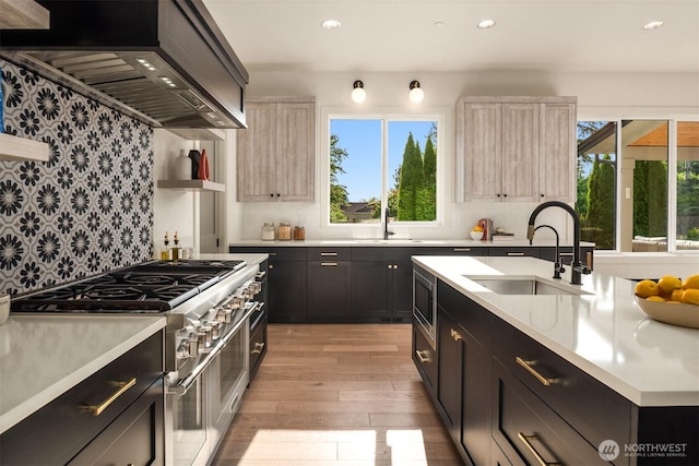 4405 88th Ave SE, Mercer Island, WA 98040 - kitchen with stainless steel appliances, wall chimney range hood, plenty of natural light, light countertops, and recessed lighting