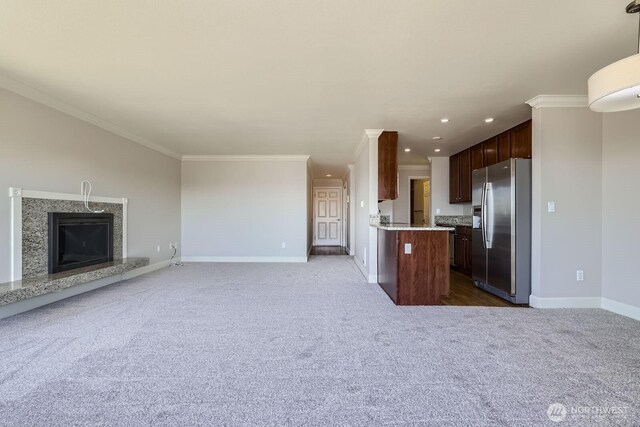 2514 57th Ave SW Unit 301, Seattle, WA 98116 - kitchen featuring stainless steel fridge with ice dispenser, open floor plan, light countertops, dark carpet, and ornamental molding