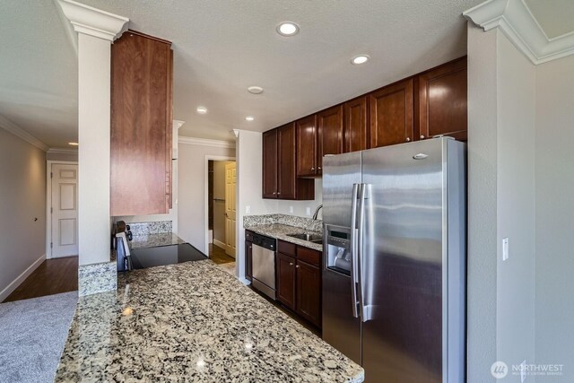 2514 57th Ave SW Unit 301, Seattle, WA 98116 - kitchen with stainless steel appliances, ornamental molding, light stone countertops, recessed lighting, and dark brown cabinets