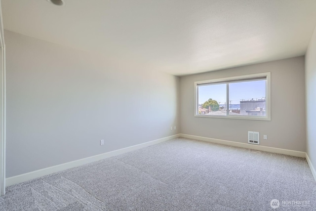 2514 57th Ave SW Unit 301, Seattle, WA 98116 - spare room featuring light carpet and baseboards